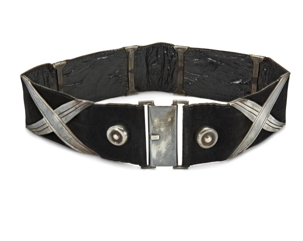 Black leather concho belt with crossed silver appliqués, domed silver studs and a rectangular silver buckle, by Héctor Aguilar