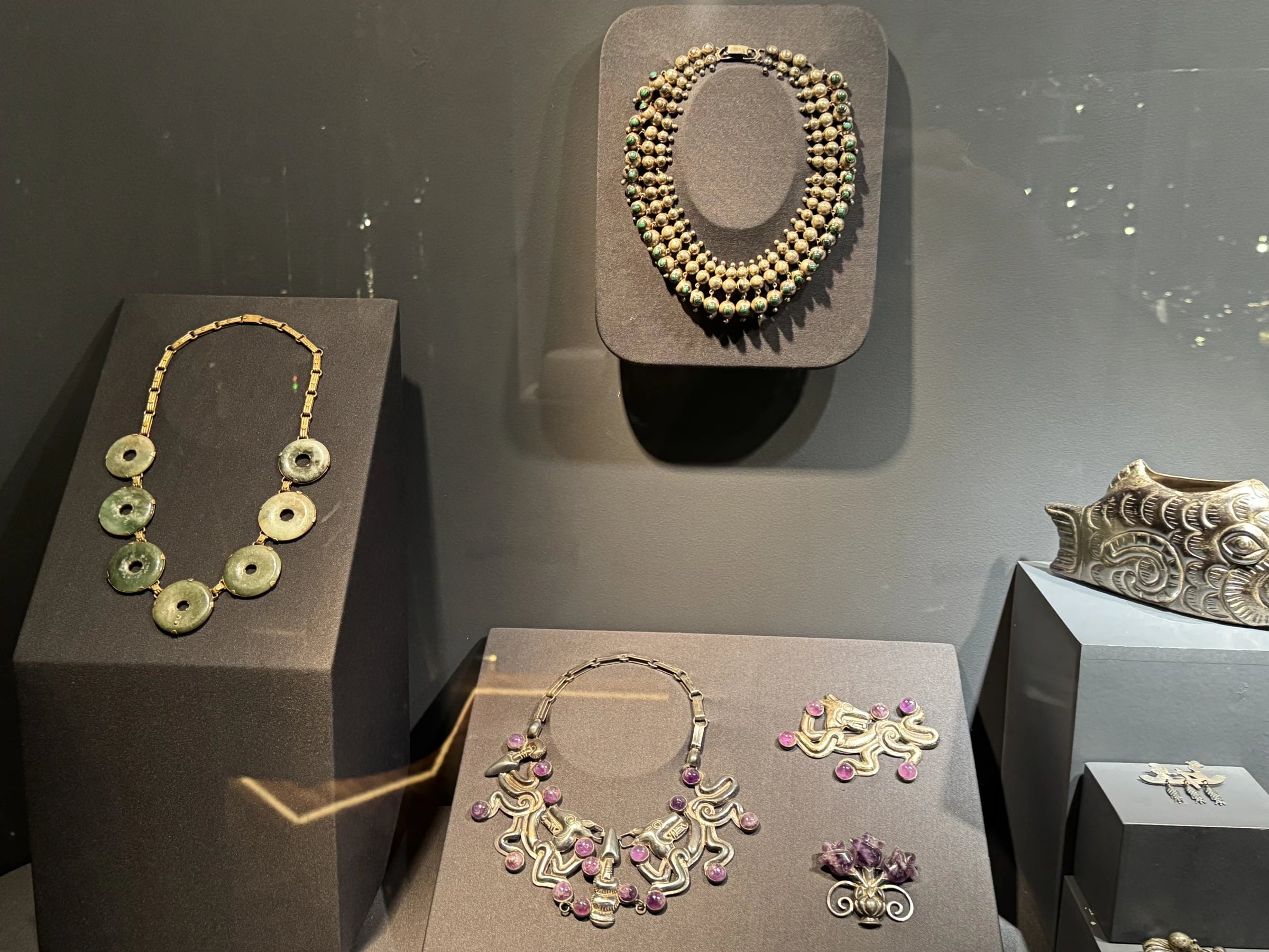 Case view: jade disc necklace, beaded necklace, amethyst-cluster suite