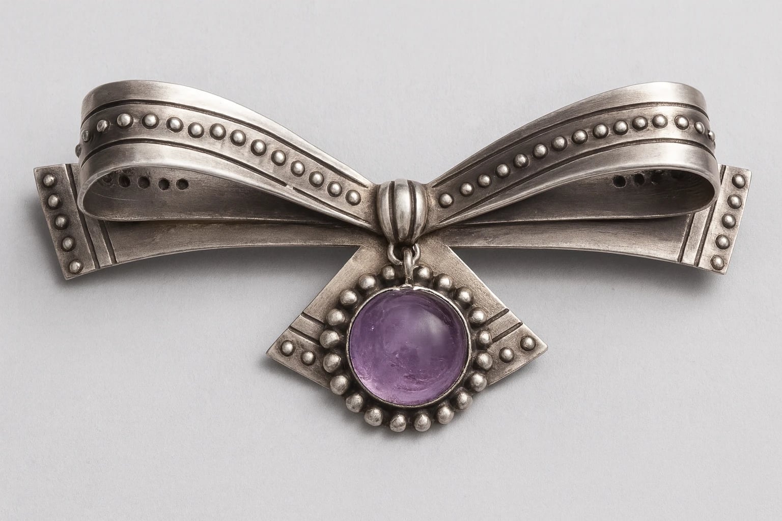 William Spratling Bow Brooch Set with Cabochon Amethyst